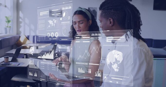 Business duo by window, woman tapping laptop causing holograms showing charts and analyzing trend