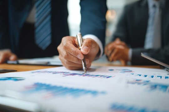 Executive reviewing financial data charts with advisor