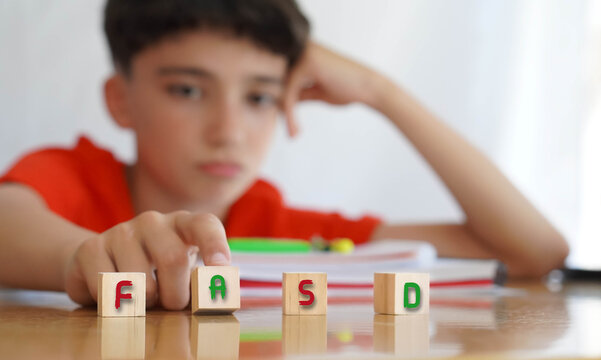 FASD. Pre-adolescent student child with the acronym for this disorder