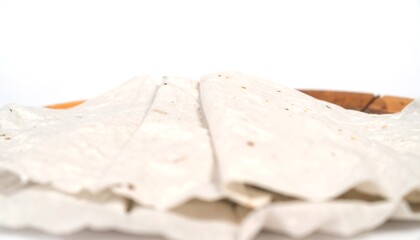 Two folded, light-colored flatbreads on a wooden plate, close-up