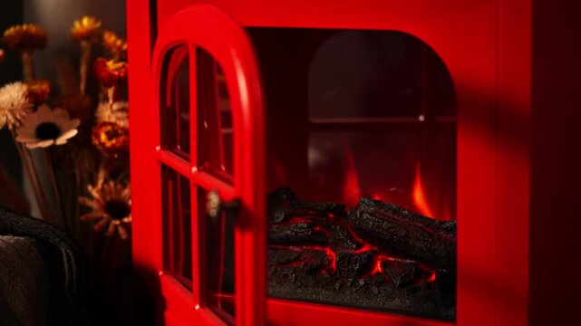 A warm and inviting winter scene with a retro red fireplace.