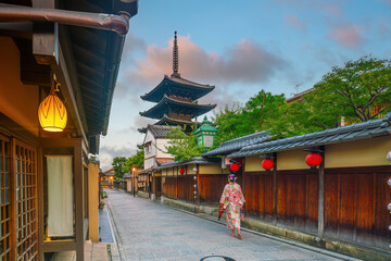 Girl wearing a traditional Japanese kimono with red umbrella  at old town  Kyoto, Japan