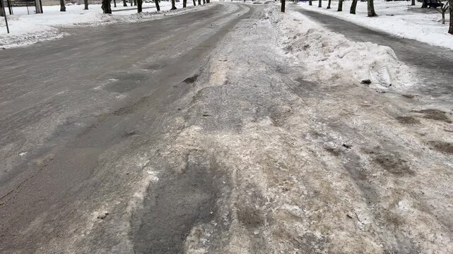 The road was covered with ice after the rain in the frost.