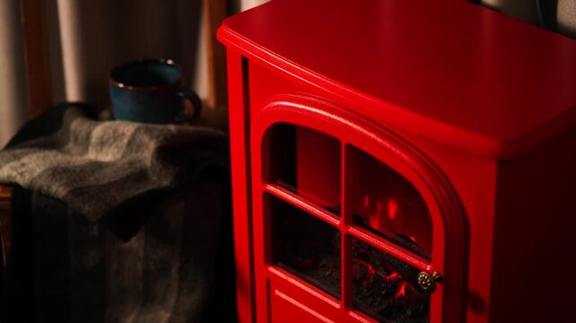 A warm and inviting winter scene with a retro red fireplace.