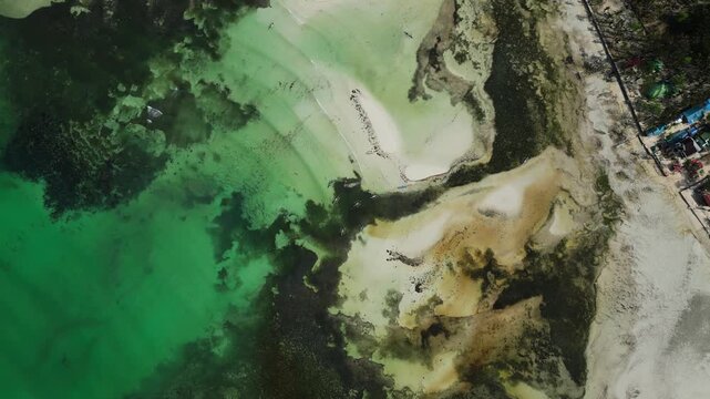 Top-down aerial emphasizing crystal clear shallow water and sandy islands at Tondol, Anda Pangasinan.