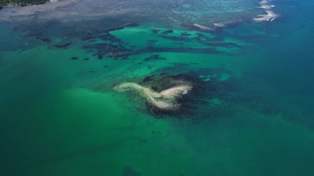 Cinematic wide drone flow over Tondol islands highlighting crystal clear water and tropical isolation.