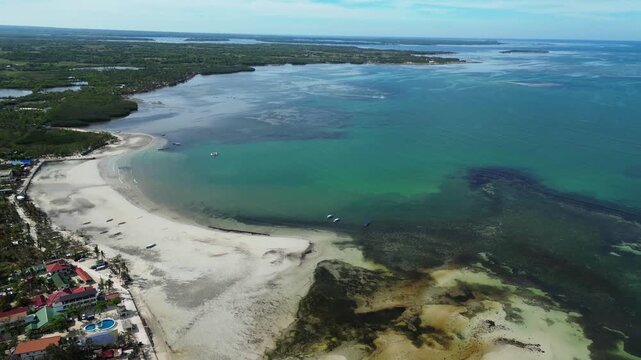 Ultra-wide aerial revealing Tondol islands surrounded by crystal clear blue and green water in Anda, Pangasinan.