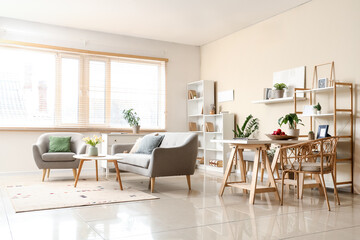 Fototapeta premium Interior of stylish living room with sofa, coffee table, carpet and window