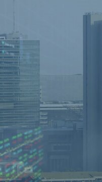 Vertical video: LED coming, left glass office showing reflection appearing, rising, peaking, fading