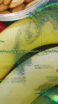 Vertical video: Camera panning down showing almonds, banana, tomatoes as glitch growing for texture