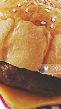 Vertical video: Camera panning sesame bun showing patty as icons floating and grouping buzz