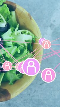 Vertical video: Bowl entering frame causing nodes clustering over salad showing network sharing