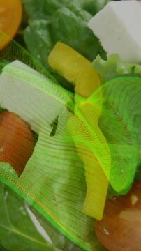 Vertical video: Green wave appearing top-left sweeping salad, creating ripples and revealing feta