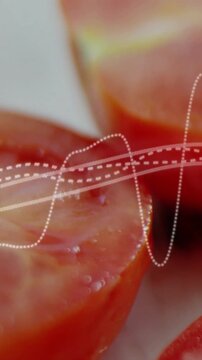 Vertical video: Camera shift sending waveform across tomato halves, showing ripeness and sheen
