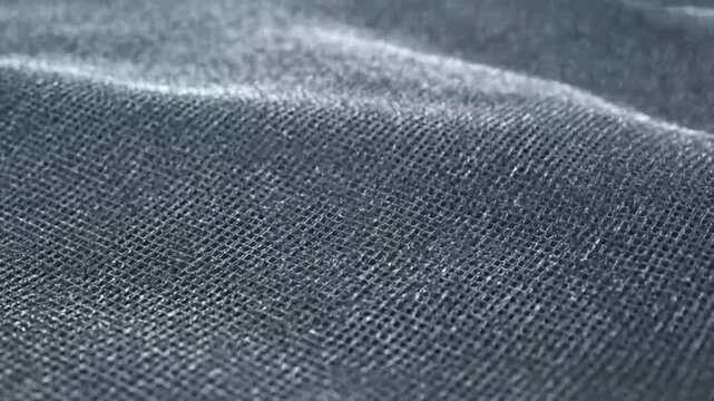 Close-up of dark blue denim fabric with textured weave pattern