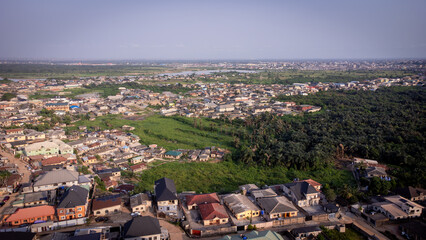 lush green vegetation scattered in-between urban civilization. © Ariyo