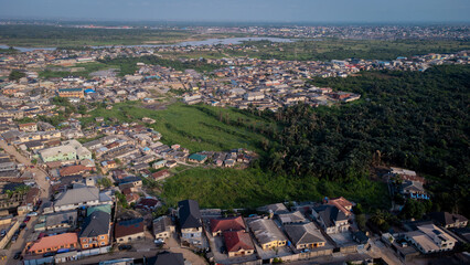 lush green vegetation scattered in-between urban civilization. © Ariyo