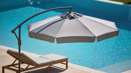 Fototapeta premium large professional cantilever umbrella in the open position, installed at the edge of a swimming pool next to a sun lounger