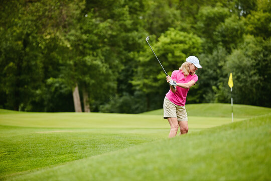 Sport, senior woman and swing on golf course for retirement hobby, technique practice or activity. Active pensioner, elderly golfer and playing match on field for morning fitness and training session
