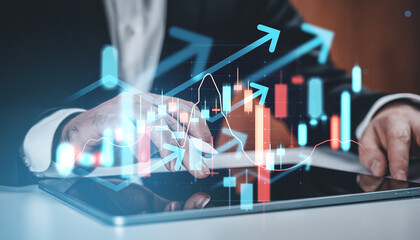 Businessman analyzing financial data on tablet with futuristic stock market interface and arrows...