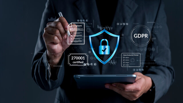Businessman using tablet with ISO 27001 certified and GDPR compliance interface icons. Concept of information security management system ISMS, data protection policy, corporate regulatory standard.