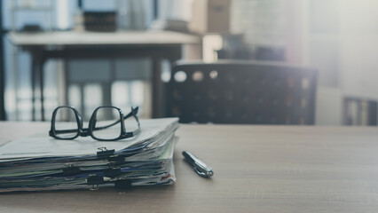 Pile of paperwork on office desk
