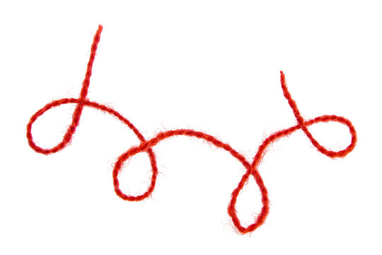 Red thread isolate on white background. Selective focus. Old.