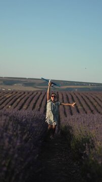 Girl running airplane lavender field childhood dream freedom Vertical video