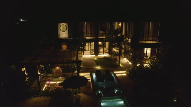Illuminated Luxury Villas At The Exclusive Getaway In Bali, Indonesia. Aerial Ascending Shot