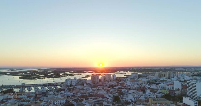 Aerial sunset over Faro city and Ria Formosa lagoon Algarve Portugal