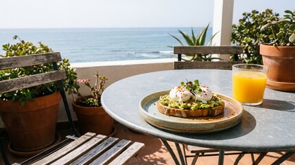 Obraz premium Poached eggs on avocado toast served on a sunny seaside balcony.