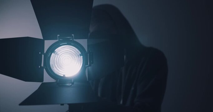 Lighting engineer setting up lights in film studio