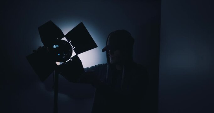 Lighting engineer setting up lights in film studio