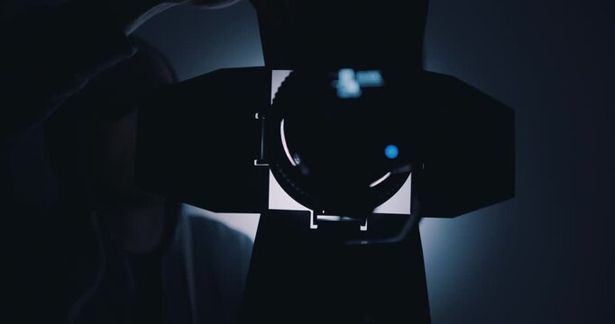 Lighting engineer setting up lights in film studio