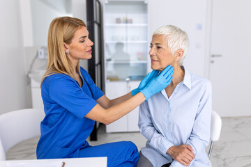Obraz premium Close Up of Healthcare Professional Examining Senior Patient Neck, Doctor Performing Thyroid Palpation for Elderly Woman, Medical Diagnostic Screening in Modern Clinic.