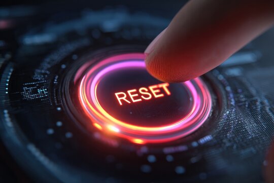 Reset Button: A finger poised to press a glowing, vibrant reset button on a sleek digital interface. The image evokes themes of change, restarting, or a fresh start. 