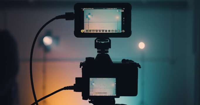 Man using clapper board in front of camera in studio