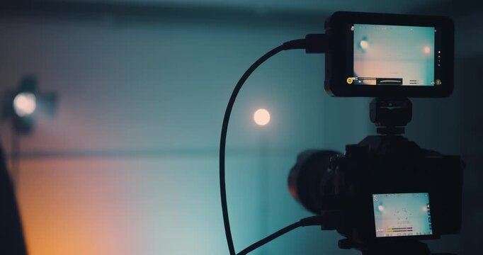 Man using clapper board in front of camera in studio