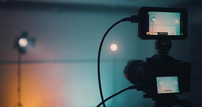 Man using clapper board in front of camera in studio