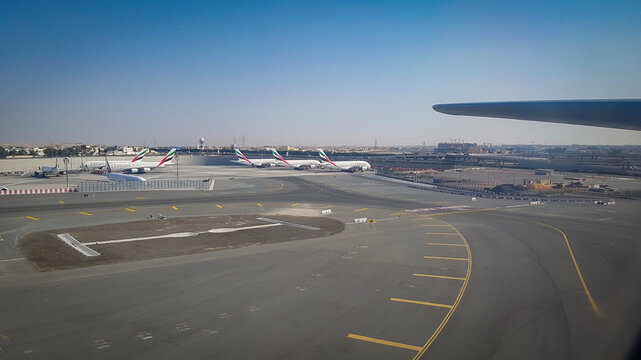 Dubai, United Arab Emirates - January 20, 2018 - View from the plane window, moments before landing, and Emirates Airbus A380s parked at Dubai International Airport