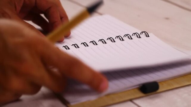 Video of hand writing on a notebook