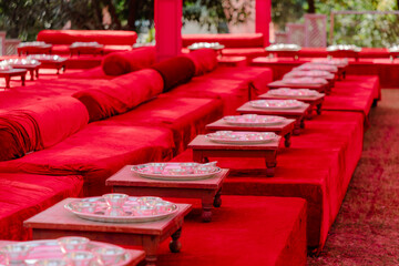 Obraz premium Festive Red Seating Arrangement with Silver Plates for a Cultural Celebration - Perfect for Events, Hospitality, and Cultural Themes. (179)