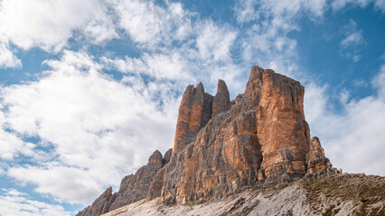 Naklejka premium Wide Dolomites mountain panorama with limestone cliffs and blue sky, South Tyrol Italy nature banner background