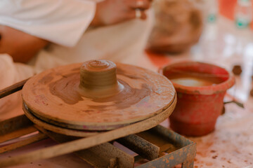 Obraz premium Crafting Clay Art: A Potter's Wheel Spins Tradition to Life, Skillful Hands Shaping Artistic Creations with Rustic Charm and Timeless Beauty