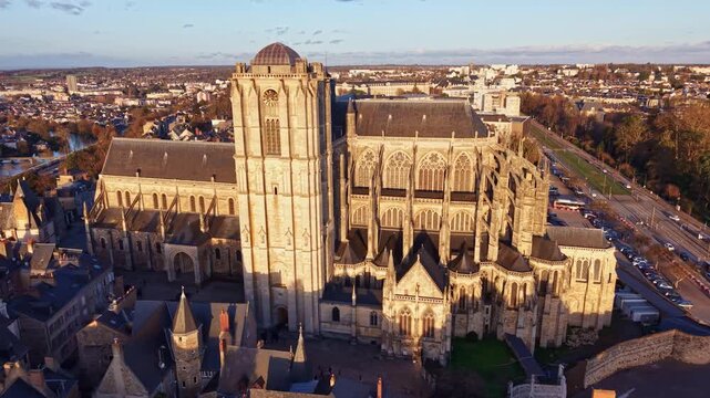 Aerial drone establishing shot of historic old town and Saint-Julien Cathedral of Le Mans at sunset in France