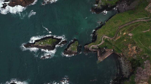 Birds skim the sea as the camera descends toward the path to Dunquin pier
