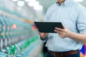 Factory worker holding tablet computer inspecting equipment in production workshop © zhu difeng