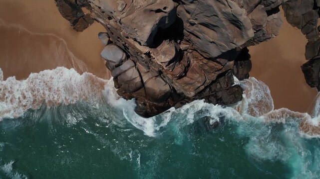 Aerial footage of crashing surf along rock formations near Cabo San Lucas