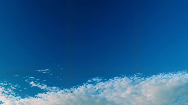 A cloudy blue sky with a few white clouds