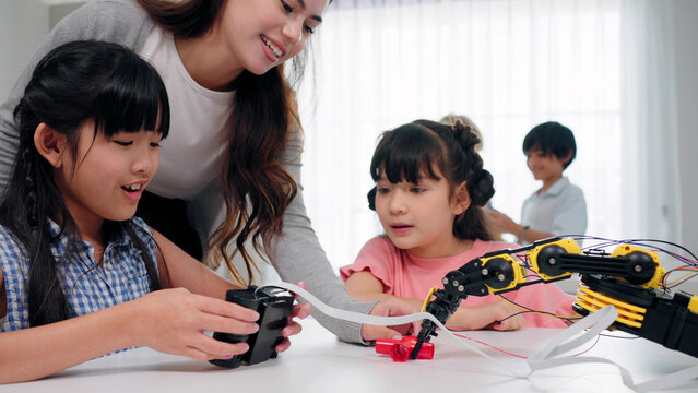 A young girl explores robotics and engineering in a STEM classroom. Hands-on technology learning, diverse elementary education, student collaboration, and future skill development
